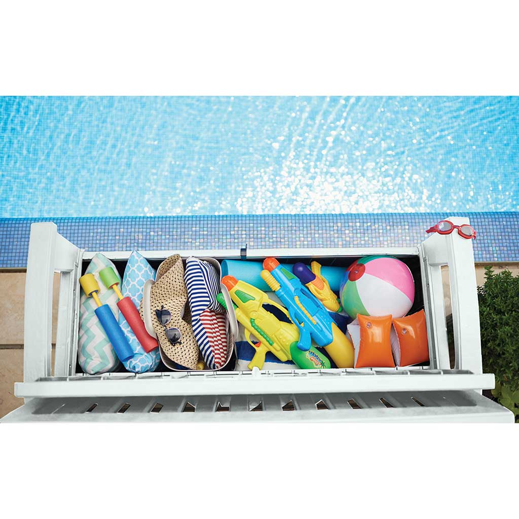 Vista cenital de banco Keter blanco con arcón abierto junto a piscina